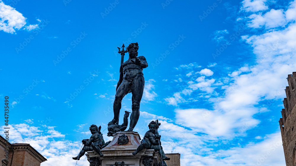 Fountain of Neptune in Bologna. statue with blue sky on the bottom