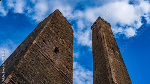 Torre degli Asinelli and Torre Garisenda seen from below with blue sky. Bologna, Italy. photo
