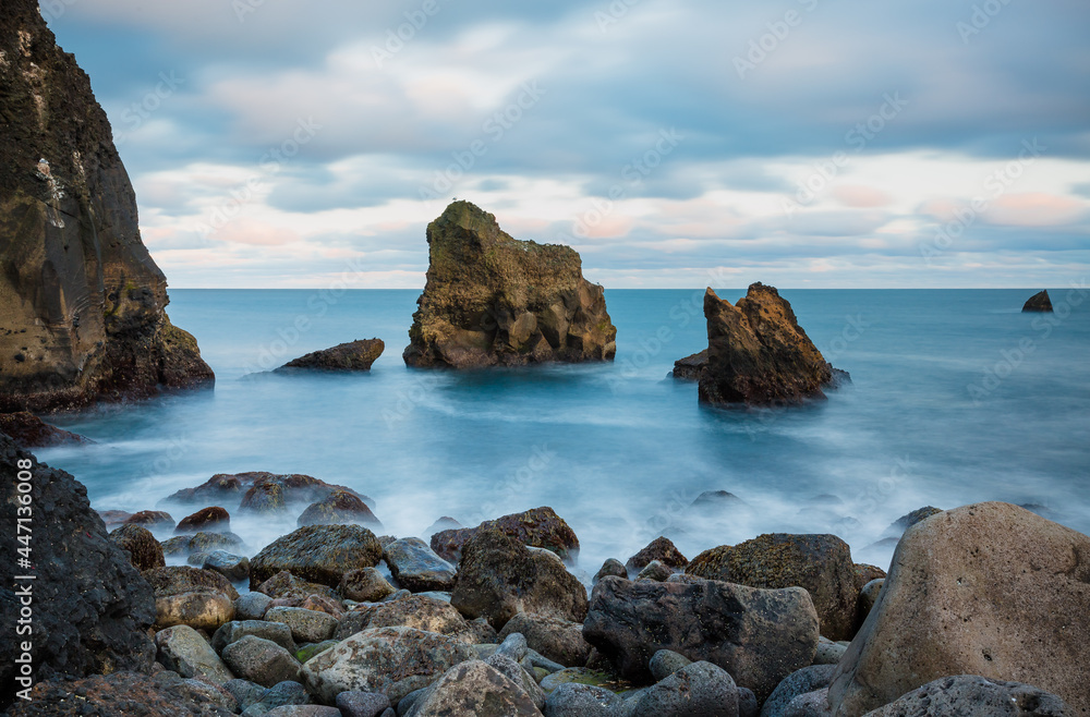 Icelandic wild coast with large rocks on the beach