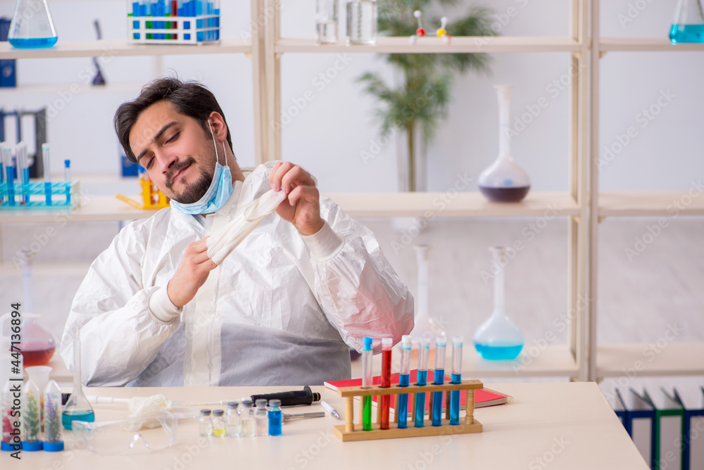 Young male chemist working at the lab during pandemic Young male chemist working at the lab during pandemic