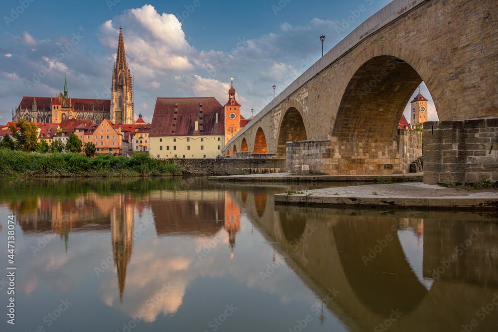 Regensburg, Germany. Cityscape image of Regensburg, Germany with Old Stone Bridge over Danube River and St. Peter Cathedral at summer sunset.