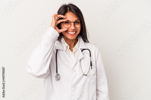 Young doctor latin woman isolated on white background excited keeping ok gesture on eye.