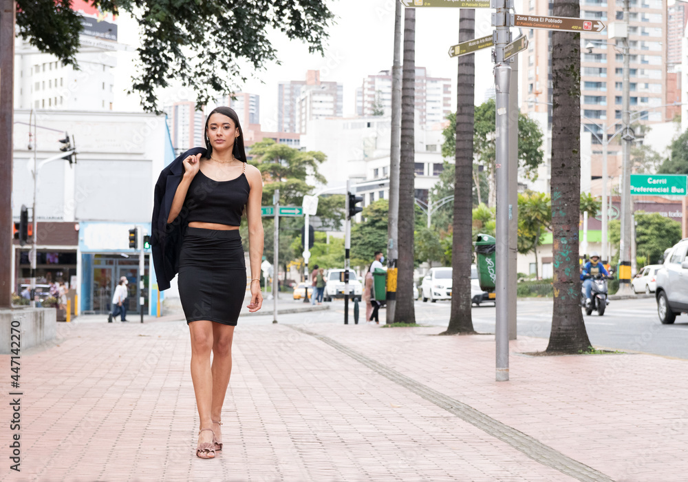Latin woman walks in the city where she lives