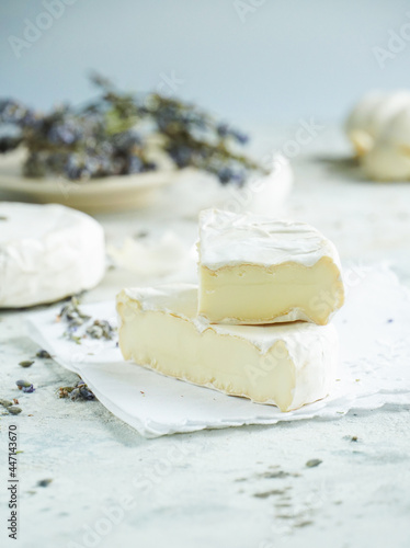 Camembert cheese on a background of garlic and lavender