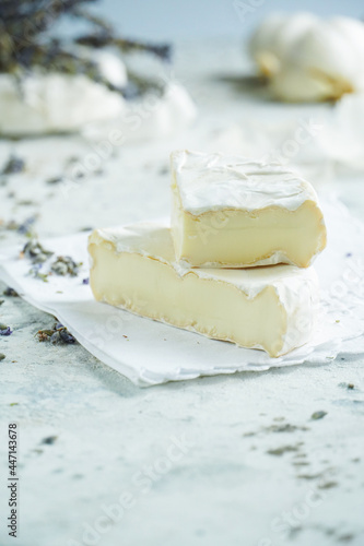 Camembert cheese on a background of garlic and lavender