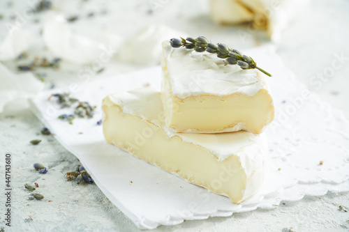 Camembert cheese on a background of garlic and lavender