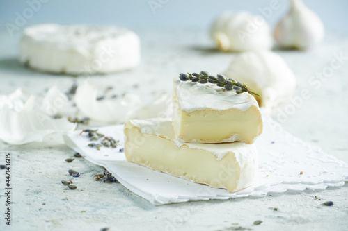 Camembert cheese on a background of garlic and lavender