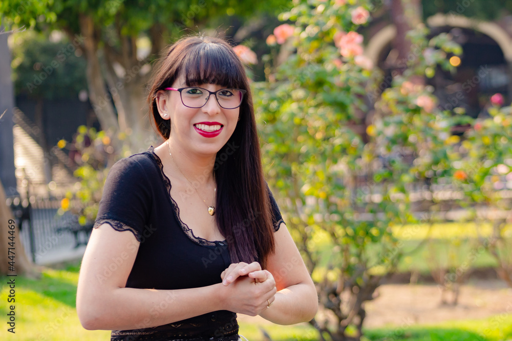 portrait of a woman with glasses smiling and laughing at the park portrait of a woman with glasses smiling and laughing at the park