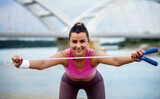 Stretching exercises. Young woman doing fitness outdoor. Sport and recreation concept