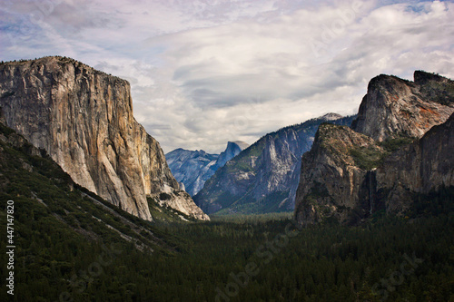 Depth of Yosemite valley with beautiful high peaks and waterfall