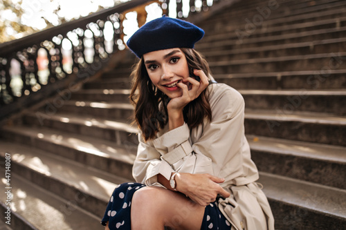 Carta da parati Cute young girl with brunette wavy hairstyle, classic outfit of beret, beige tre