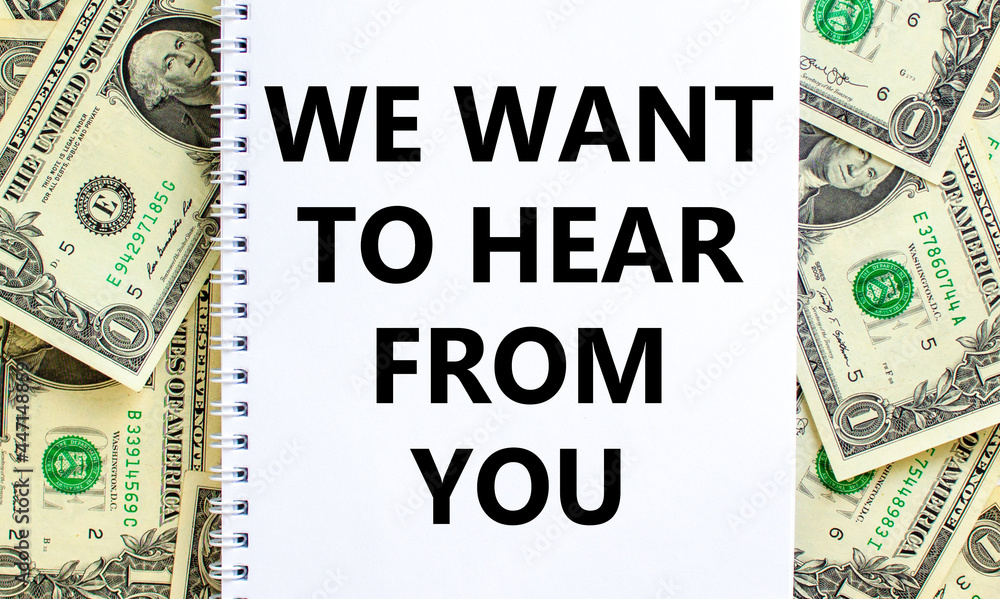 Support symbol. Words 'we want to hear from you' on white note. Beautiful background from dollar bills. Copy space. Business and support concept. Support symbol. Words 'we want to hear from you' on white note. Beautiful background from dollar bills. Copy space. Business and support concept.