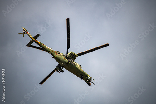 helicopters blow out a stream of smoke and make complex figures in flight against the background of the sky 