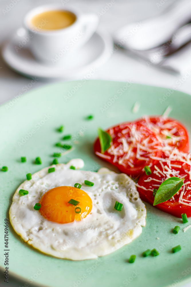 Breakfast with egg and tomatoes with cheese, low shallow focus Breakfast with egg and tomatoes with cheese, low shallow focus