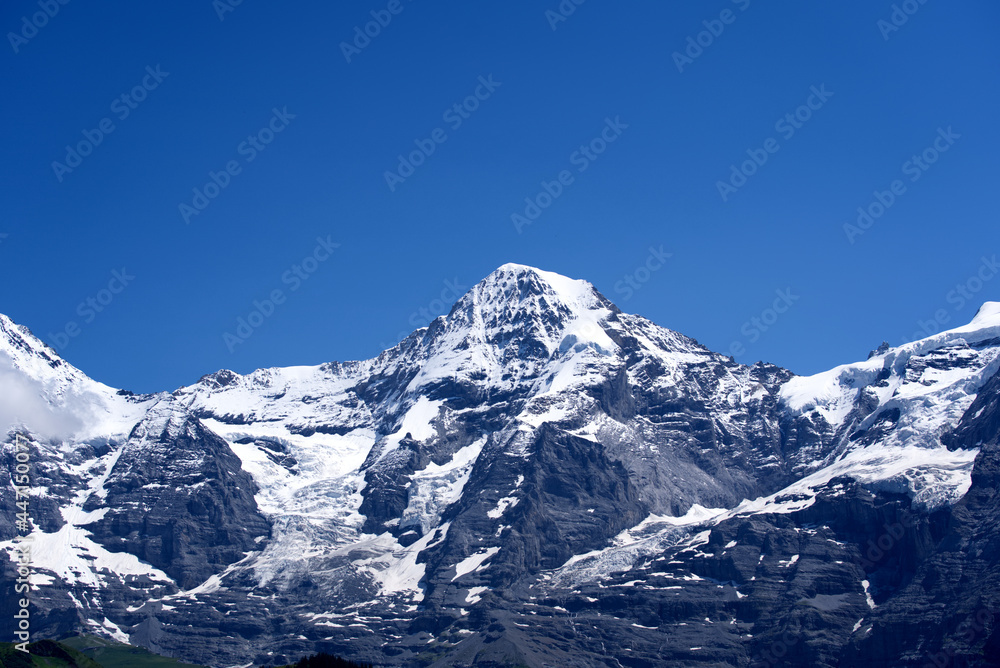 Fototapeta premium Peak Mönch (Monk) at Bernese highland on a sunny summer day with blue sky background. Photo taken July 20th, 2021, Lauterbrunnen, Switzerland.