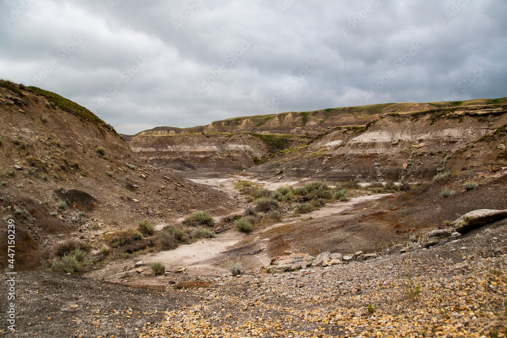 A stark view of the Alberta badlands just outside the Royall Tyrrell Museum of Paleontology in Drumheller, Alberta on a dark and gloomy day. A stark view of the Alberta badlands just outside the Royall Tyrrell Museum of Paleontology in Drumheller, Alberta on a dark and gloomy day.