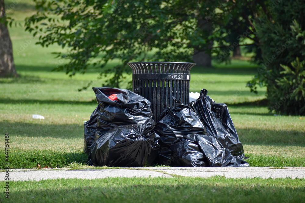 Premium Photo  Black garbage bag standing on the ground near a tree  outdoors