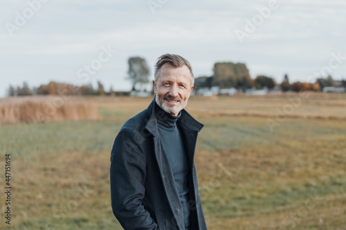 Middle-aged man enjoying a walk in a wintry countryside