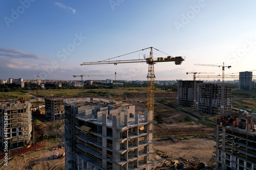 Сonstruction site with tower cranes during conctruct the high-rise building. Cranes at the pouring concrete into the formwork. Construction and the built environment. Buildings renovation photo