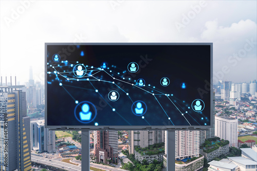 Glowing Social media icons on road billboard over panoramic city view of Kuala Lumpur, Malaysia, Asia. The concept of networking and establishing new connections between people and businesses in KL.