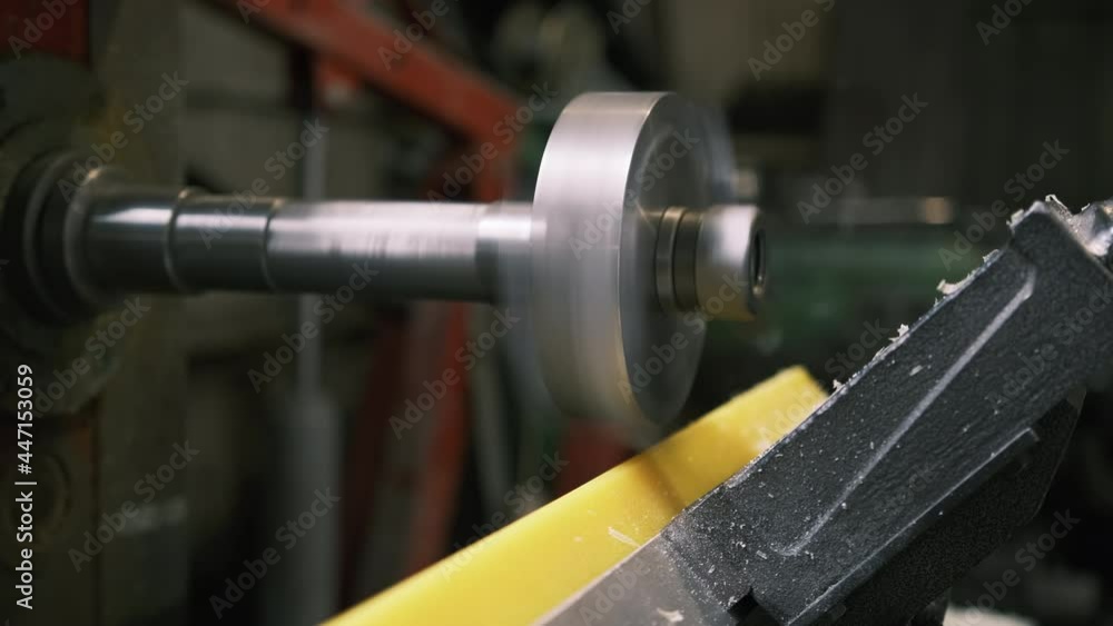 Close-up. A milling cutter on a horizontal milling machine processes a polyurethane part according to a drawing or a sample at the factory. Milling machine during work Close-up. A milling cutter on a horizontal milling machine processes a polyurethane part according to a drawing or a sample at the factory. Milling machine during work