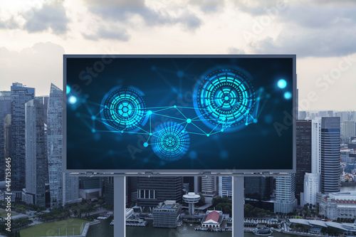 Glowing hologram of technological process on billboard, aerial panoramic cityscape of Singapore at sunset. The largest innovative hub of tech services in Southeast Asia.