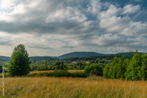 Lookout place with bench and old house near Lenora village in summer evening