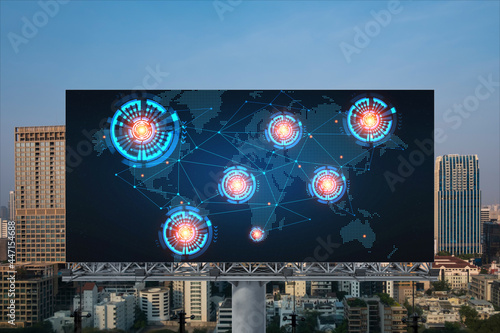 Glowing hologram of Earth planet map on billboard over aerial panoramic cityscape of Bangkok at sunset. The concept of international business in Southeast Asia.