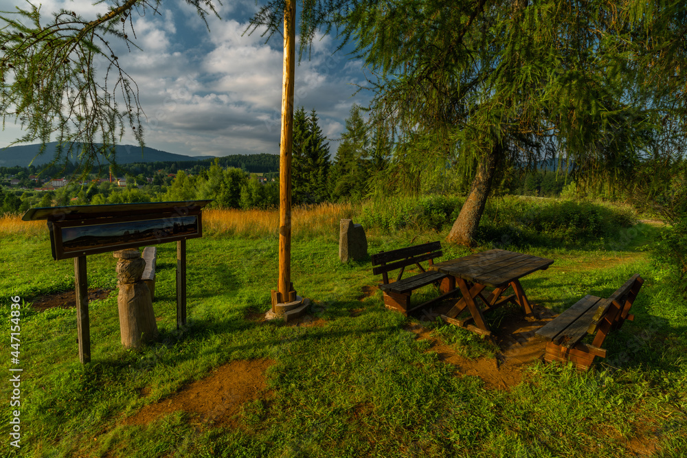 Lookout place with bench and old house near Lenora village in summer evening Lookout place with bench and old house near Lenora village in summer evening