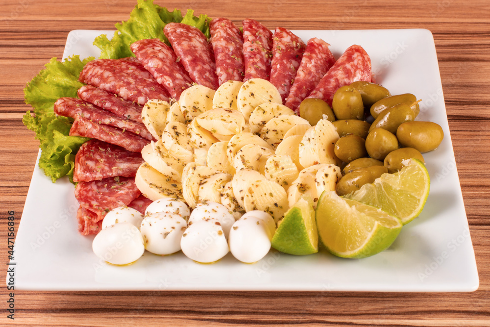 portion of cheese and salami on wooden background