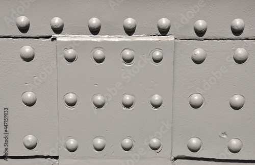 Industrial steel plate with grey round rivets