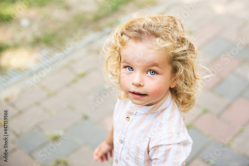 Handsome boy with blue eyes and curly blond hair