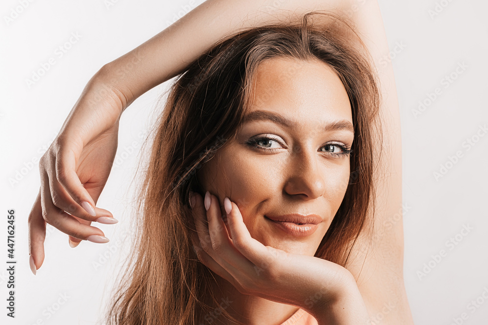 Beautiful young girl smiling and posing looking at the camera on a white isolated background. Positive brunette woman. Kind look. Beauty face Beautiful young girl smiling and posing looking at the camera on a white isolated background. Positive brunette woman. Kind look. Beauty face