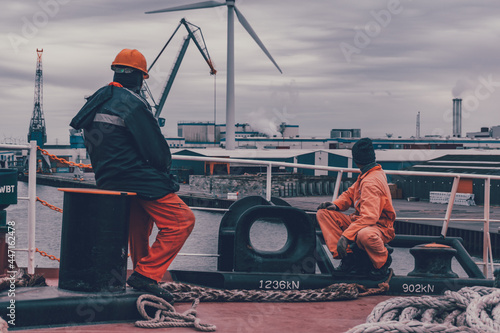 Seafarers watching windturbine during ship manouvering v2 photo