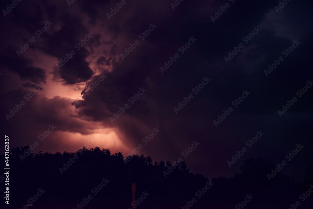 fantastic shots of shooting a night thunderstorm. lightning flashes in the depths of the storm clouds, illuminating the night sky with light. travel, natural phenomena. night shooting