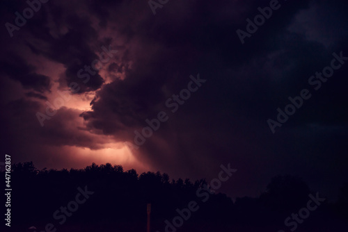 fantastic shots of shooting a night thunderstorm. lightning flashes in the depths of the storm clouds, illuminating the night sky with light. travel, natural phenomena. night shooting