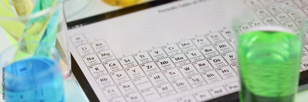 Digital tablet with periodic system of elements lying on table in laboratory closeup Digital tablet with periodic system of elements lying on table in laboratory closeup