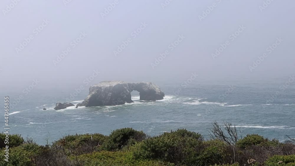 Arched rock in the ocean at Goat Rock Beach State Park in Northern California Arched rock in the ocean at Goat Rock Beach State Park in Northern California