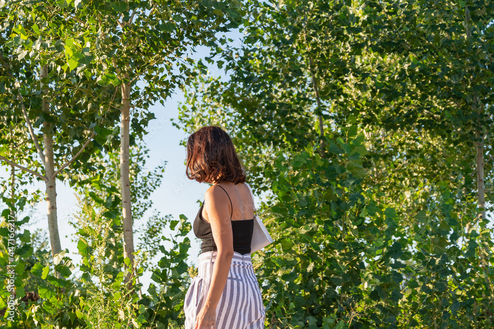 Young woman walks in the park. Young woman walks in the park.