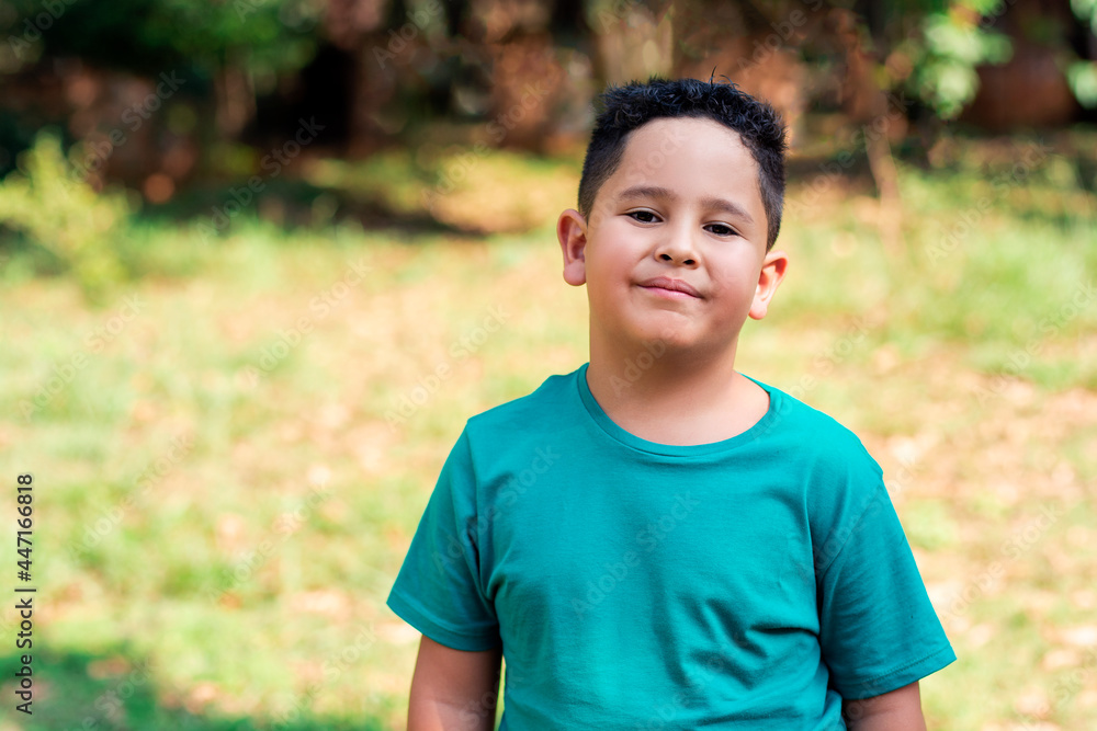 friendly little brazilian boy smiling with nature in the background. friendly little brazilian boy smiling with nature in the background.