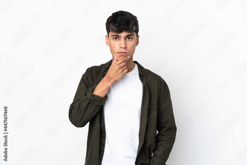 Young man over isolated white background thinking