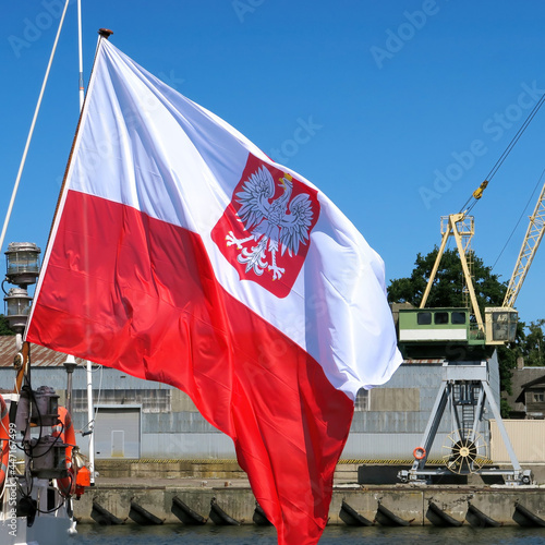 The national flag of Poland on the stern flagpole of the ship.