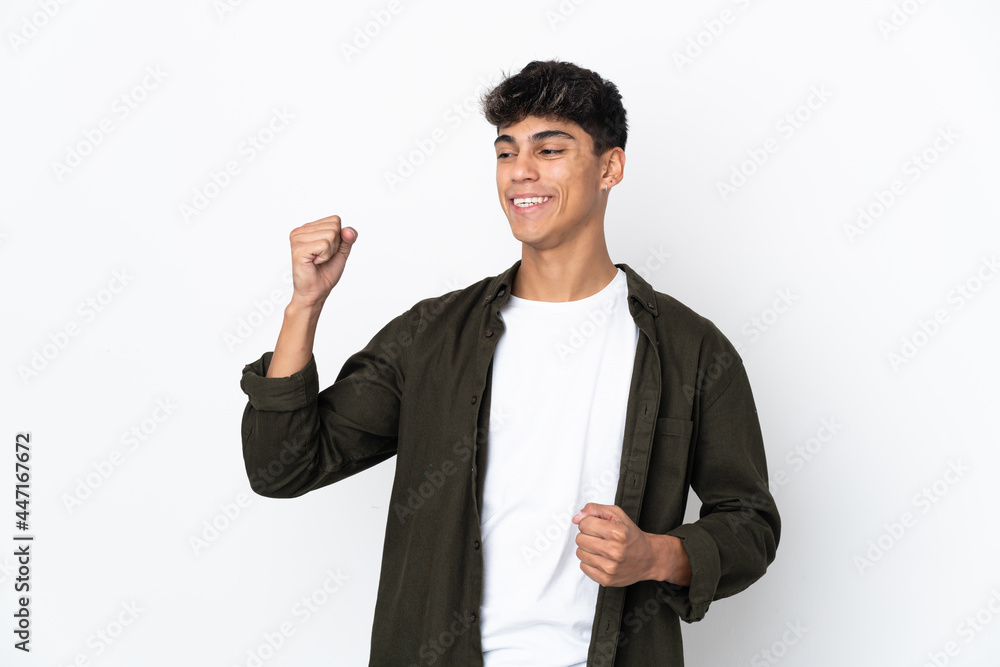 Young man over isolated white background celebrating a victory Young man over isolated white background celebrating a victory