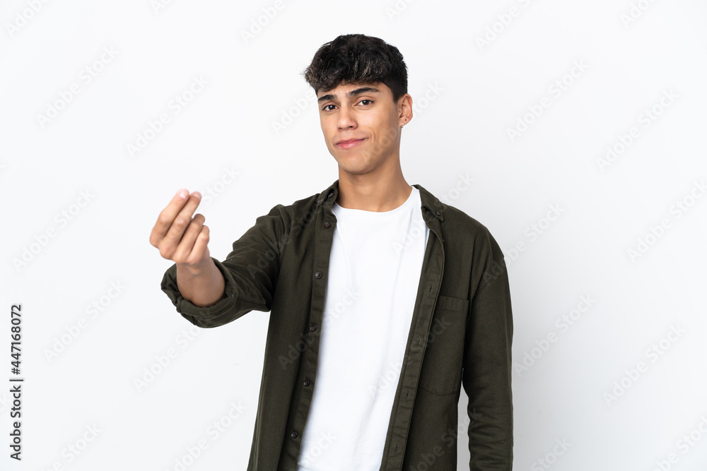 Young man over isolated white background making money gesture Young man over isolated white background making money gesture