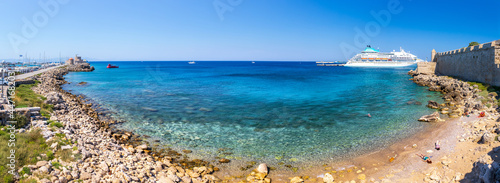 Panoramic view of beach, harbor and marina from Saint Paul's Gate of ancient city. Mooring yachts and vessels. Crystal clear turquoise water. A summer vacation in a Rhodes, Dodecanese, Greece.