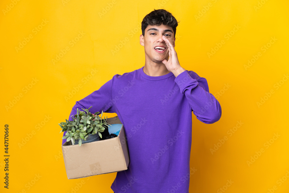 Man making a move while picking up a box full of things shouting with mouth wide open Man making a move while picking up a box full of things shouting with mouth wide open
