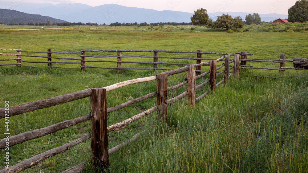 fence in the field mountain background fence in the field mountain background