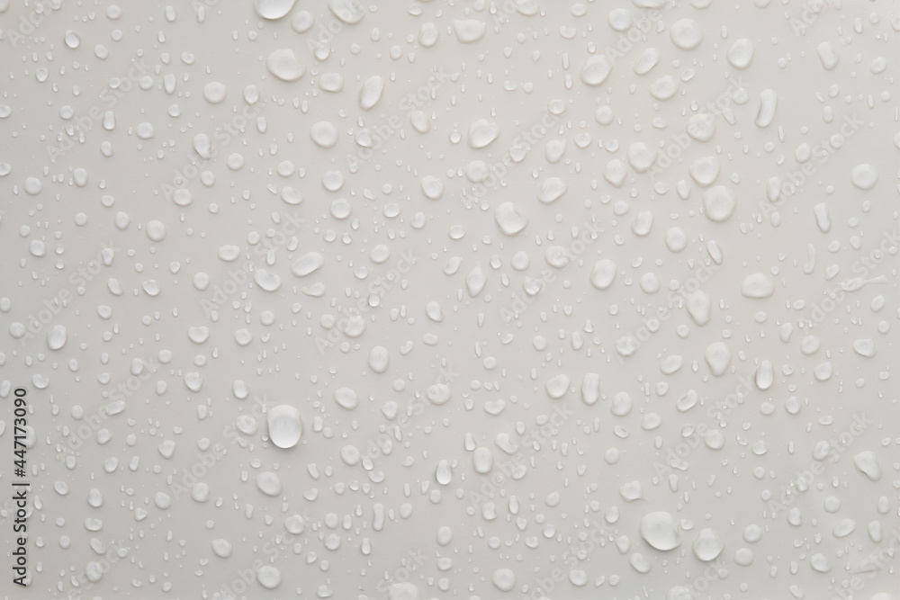 Water droplets on shiny white metallic surface Water droplets on shiny white metallic surface