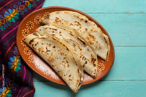 Mexican food. Quesadillas on turquoise background