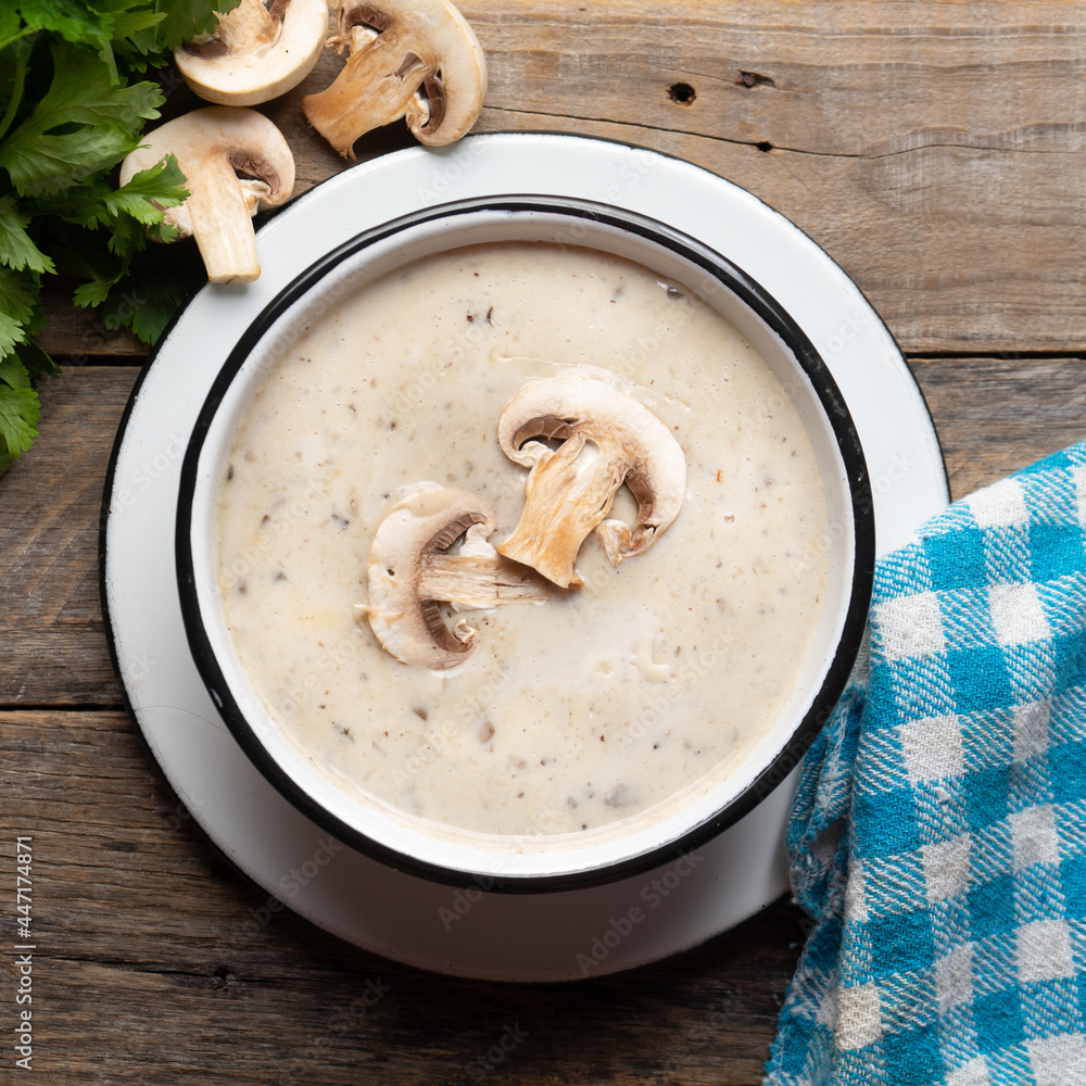 Cream of mushroom soup on wooden background. Vegetarian food Cream of mushroom soup on wooden background. Vegetarian food